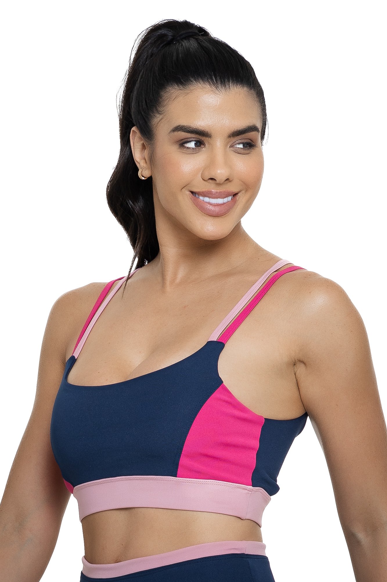 Top fitness com alça dupla azul marinho e rosa com recortes visto de lado, ideal para treinos com estilo e praticidade.