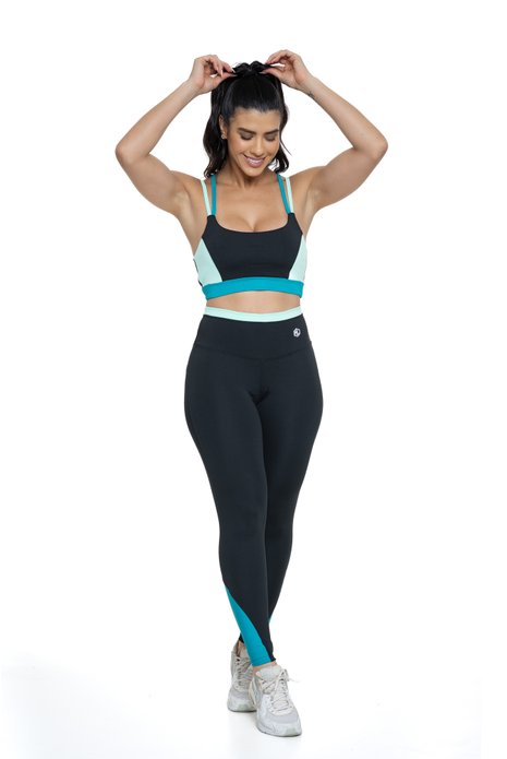 Conjunto fitness preto e verde com recortes visto de frente, projetado para conforto e mobilidade, ideal para treinos com estilo e praticidade.