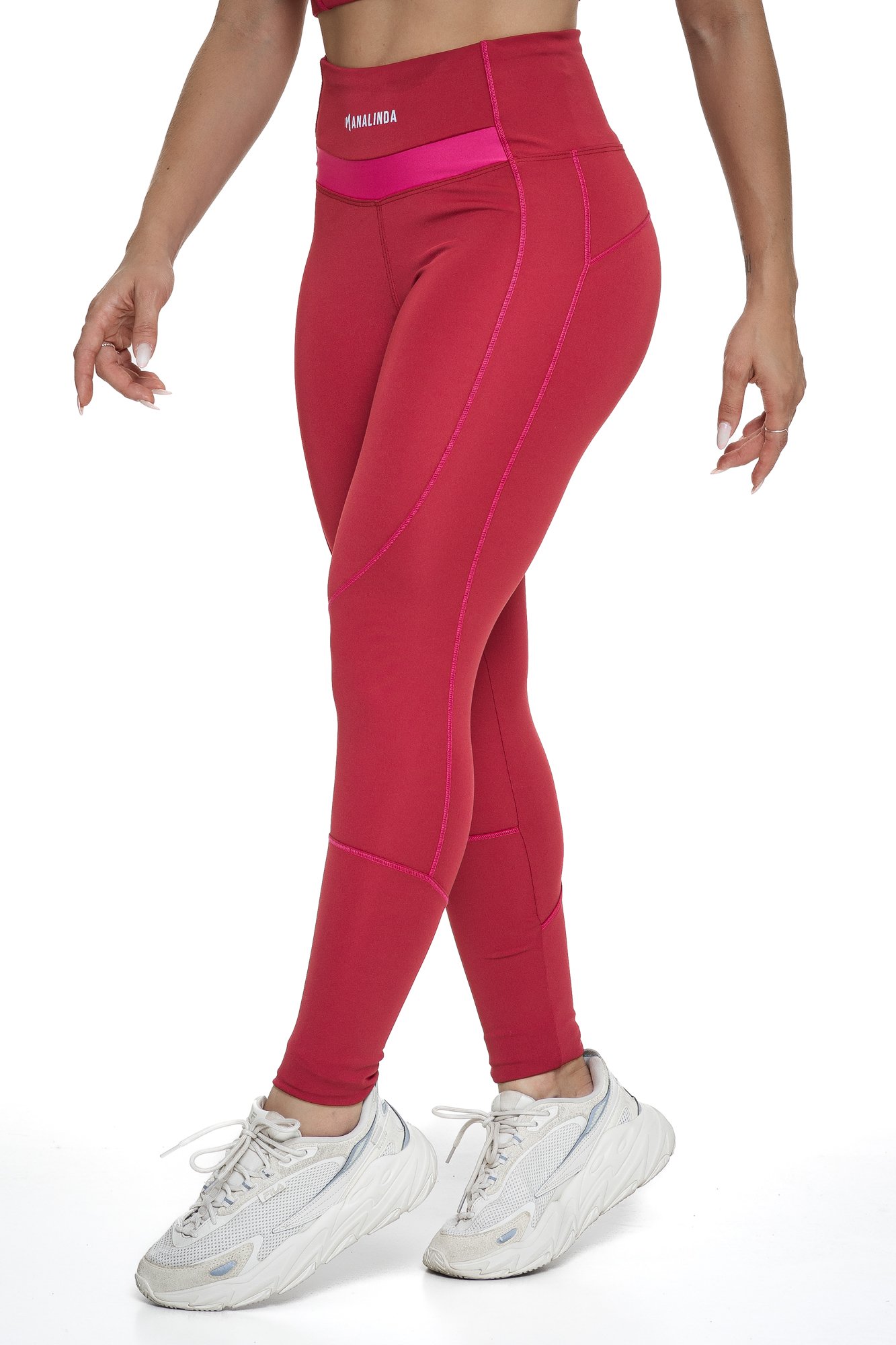 Legging feminina bordô e magenta com recortes visto de lado, projetado para conforto e mobilidade, ideal para treinos com estilo e praticidade.